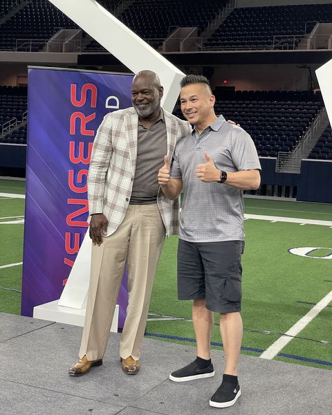 Dan with Emmitt Smith on a football field
